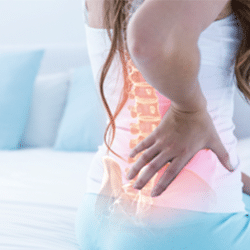 relieving lower back pain woman holding hurting back