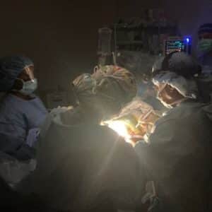 Q&a with dr. Anthony carter on his medical mission trip to honduras 5 Dr. Carter performing surgery in a dim room