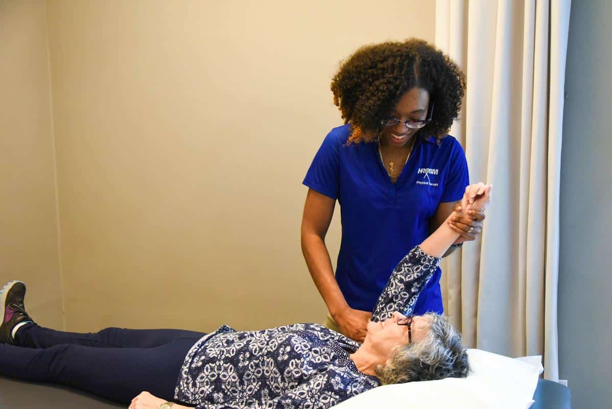 Shannon Physical Therapist helping patient with arm physical therapy center