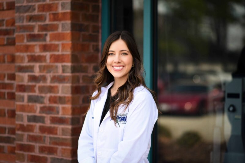 Hrosm-claire cogsdale p. A-c Claire cogsdale, pa-c headshot outside in white coat spine care