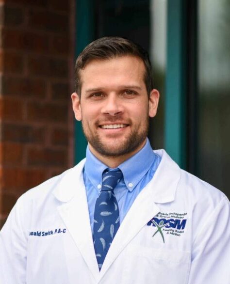 Ronald smith, pa-c headshot outside in white coat