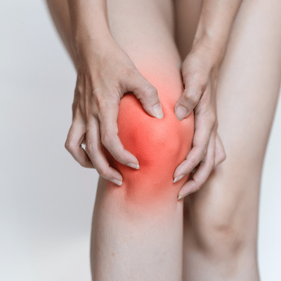 Orthopedic solutions for arthritis pain 4 Person holding knee that's red to illustrate arthritis pain